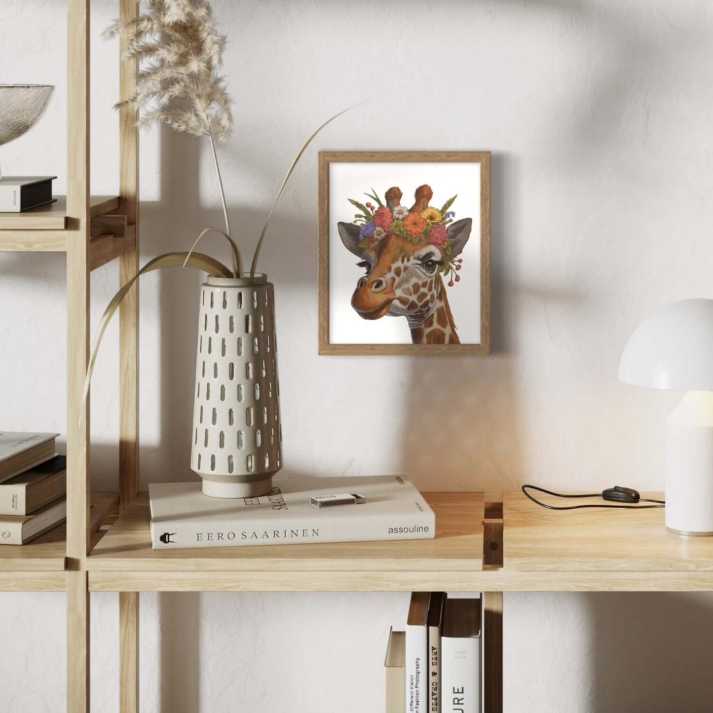 Framed print of a giraffe with flowers in a stylish interior setting, showcasing eco-friendly design.