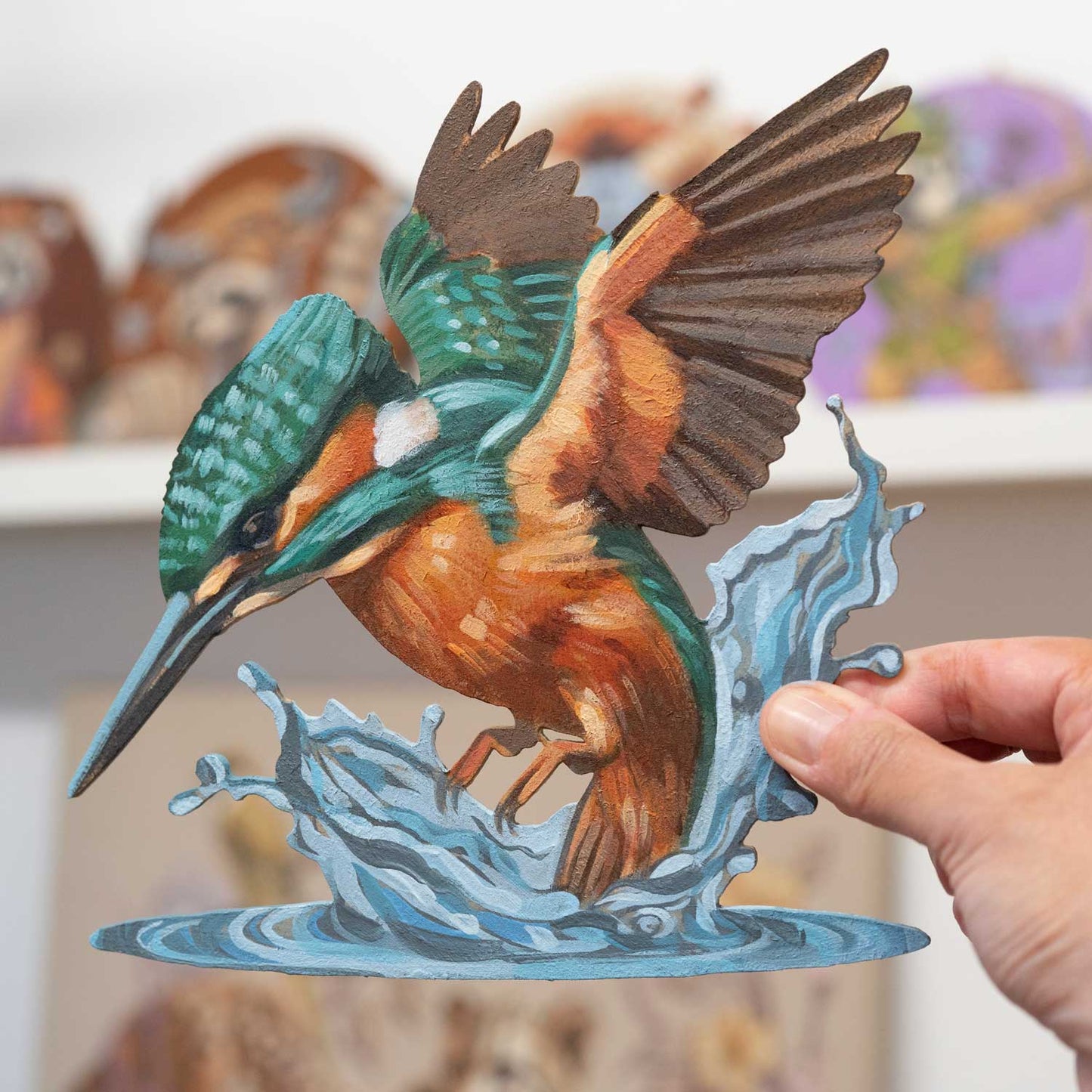 Hand-painted retro sign featuring a kingfisher diving into water, showcasing vibrant colors and fine details.