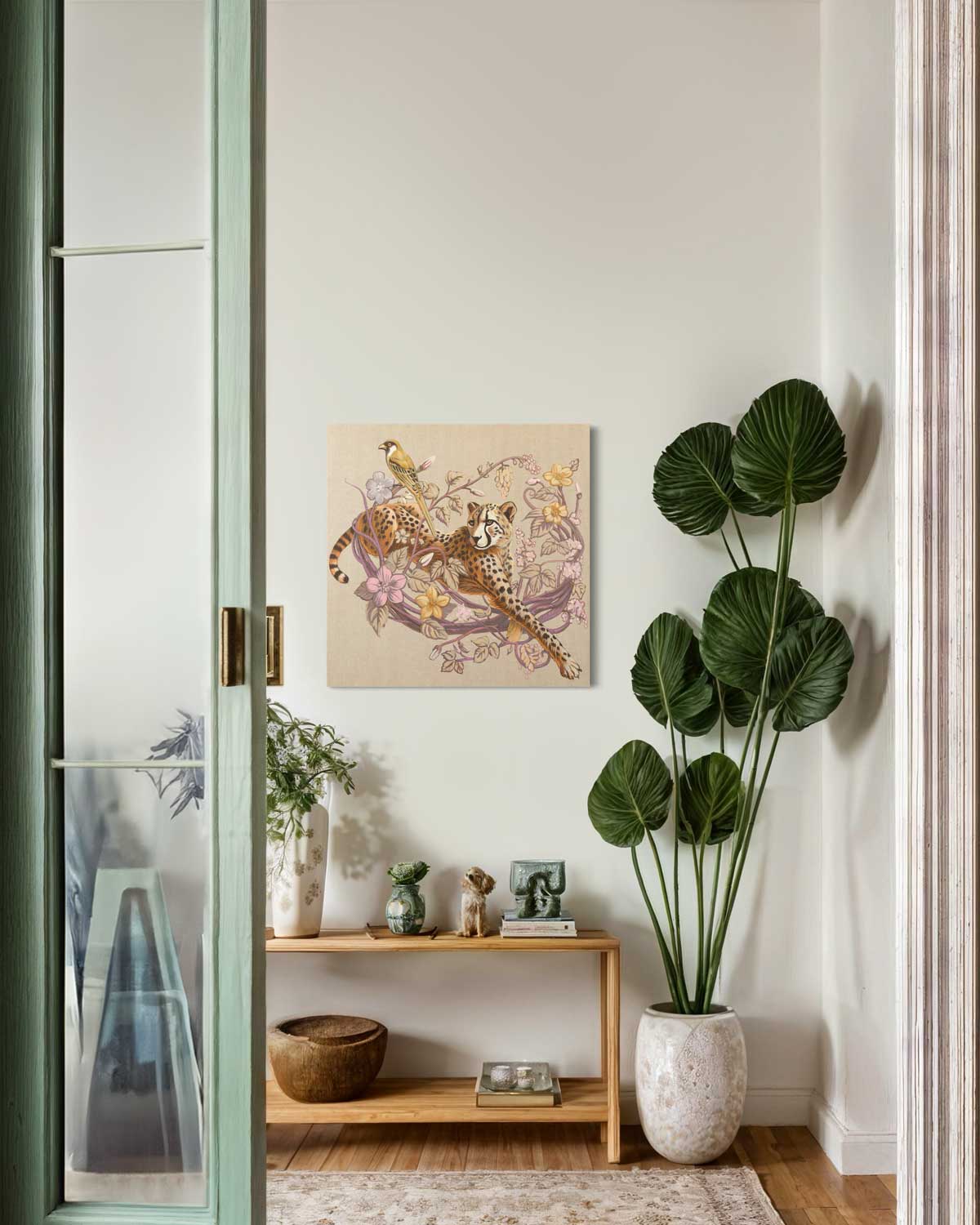 Original hand-painted acrylic artwork of a cheetah with a bird, elegantly displayed in a modern home interior.